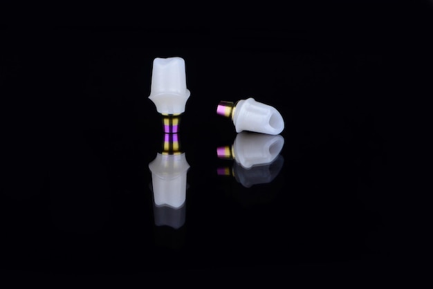 Two pieces of individual zirkonium abutments connected to titanium abutments screw retained