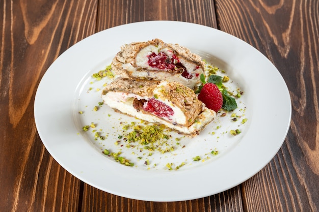 Two pieces of strawberry tart on white plate