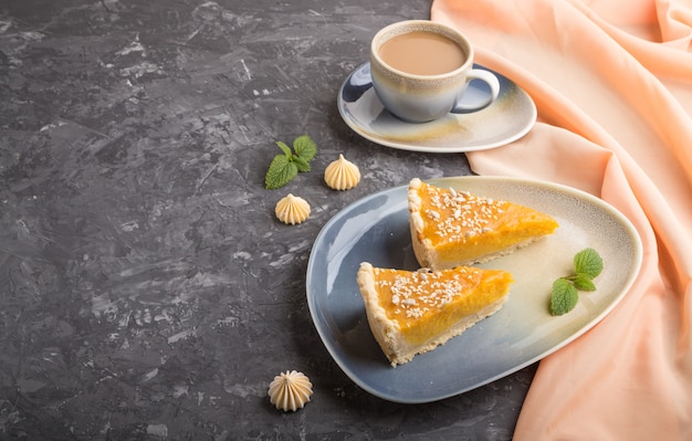 Two pieces of traditional american pumpkin pie with cup of coffee. side view, copyspace.