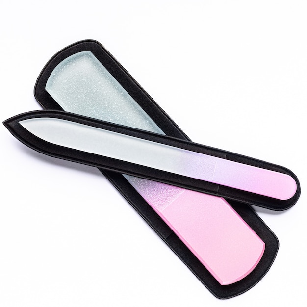 Two pink glass nail files with case on white background