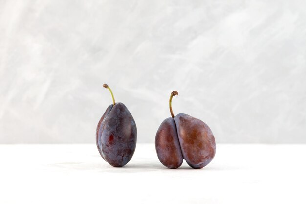 Two plums normal and ugly fruit Deformed Fused prune Double fruit Food waste reduction