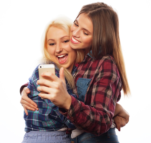 Two pretty hipster girls taking selfie Isolated on white background