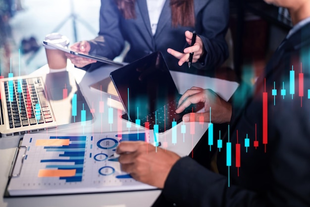 Two professional traides on technical price graph and indicator, red and green candlestick chart and stock trading computer at office