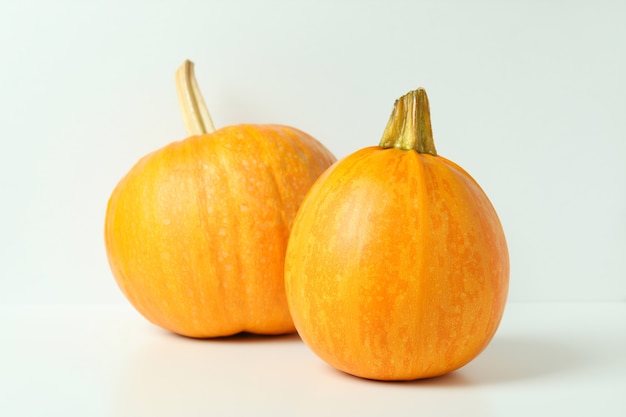 Two pumpkins on white background, close up