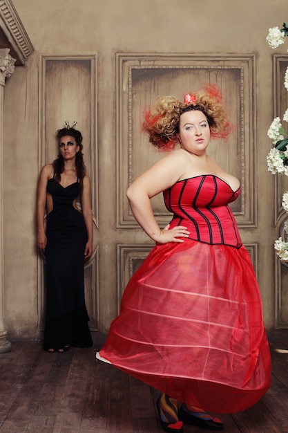 Two queens in carnaval dress. Black and red.