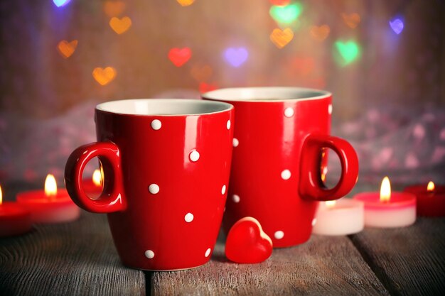 Two red cups on table on lights background