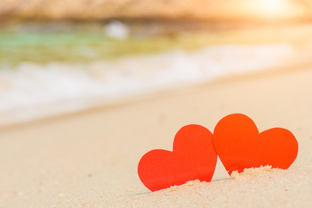 Two red hearts on the summer beach. Love, Wedding and Valentines day concept. 