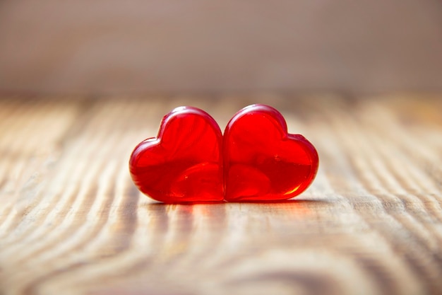 Two red hearts on wooden background, close-up, Valentine's day
