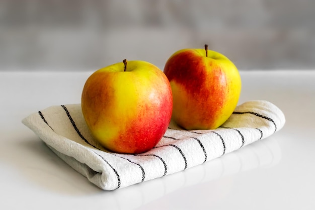 Two redgreen apples on a light background