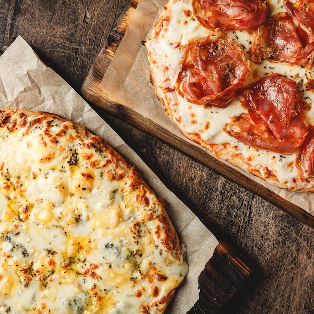 Two Romanstyle pizzas with cheese and jamon serrano Roman square pizza or Pinsa on thick dough