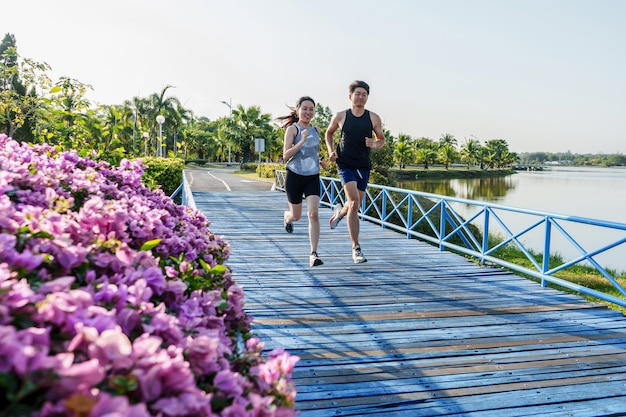 Two runners running together on the bridge in the morning