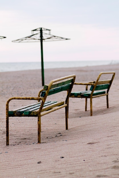 Two rusty benches on the beach