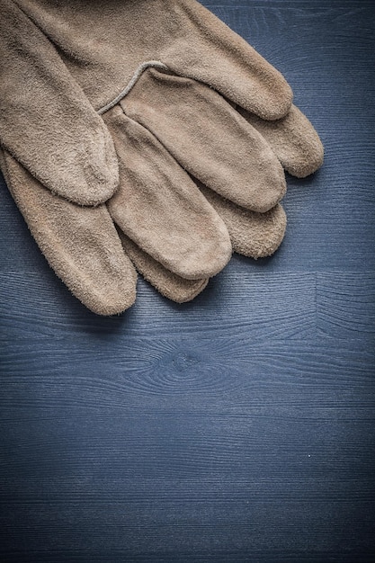 Two safety gloves on blue board