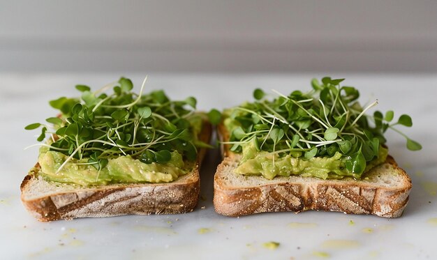 Photo two sandwiches with avocado on them are on a counter