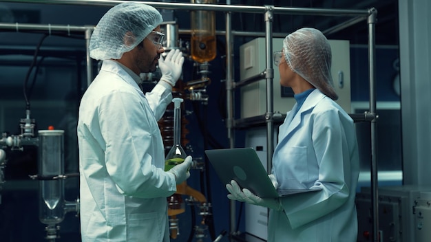 Two scientist in professional uniform working in laboratory for chemical and biomedical experiment