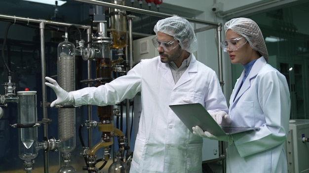 Two scientist in professional uniform working in laboratory