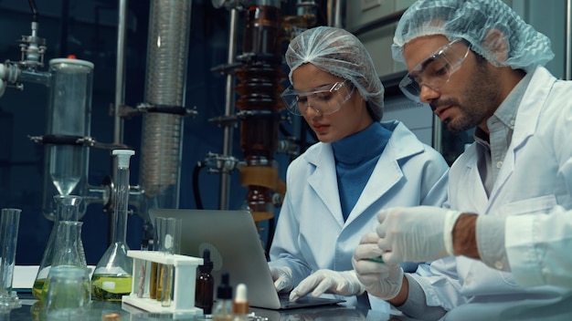 Two scientist in professional uniform working in laboratory