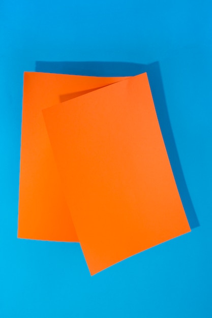 Two sheets of orange paper on a blue background for decoration, for text design, for a template