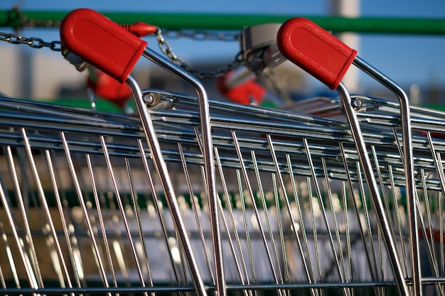 Two shopping carts connected by a chain