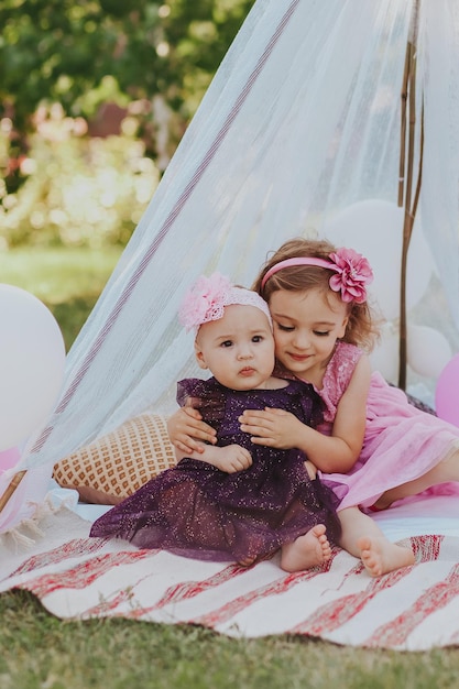 two sisters having fun in garden