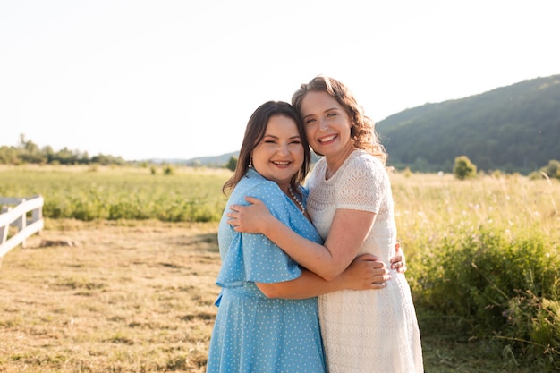 Two sisters hugging each other at the farm