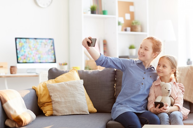 Two Sisters Taking Selfie at Home