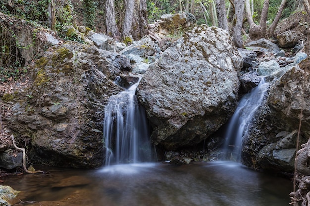 Two small waterfall in the rocks in the forest