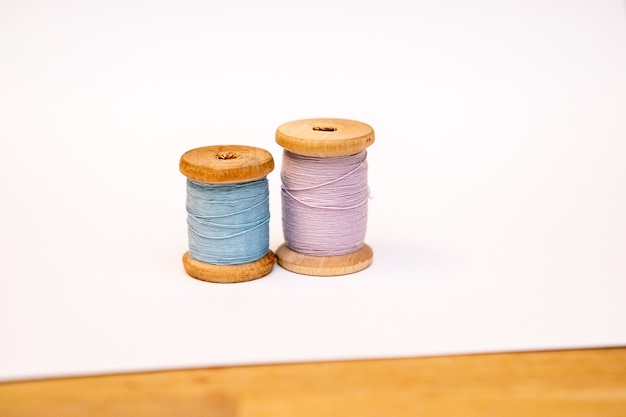 Two spools of thread on a white background