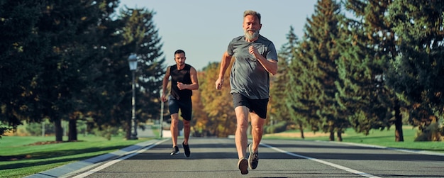 The two sportsmen running on the road