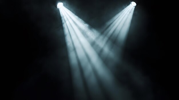 Photo two spotlights illuminating a dark smoky stage