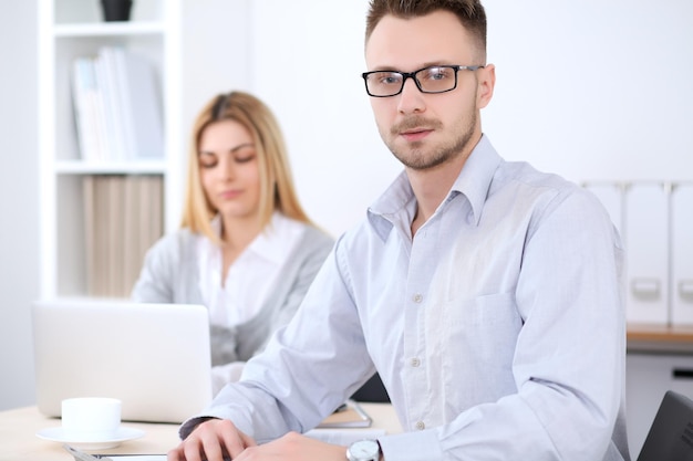 Two successful business partners working at meeting in office Focus on man