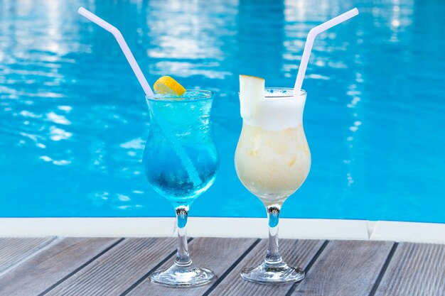 Two summer sweet cocktails by the pool.