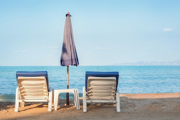 Two sun loungers on the beach. Sunbathing area