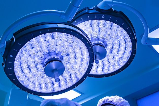 Two surgical lamps in operation room take with blue filter