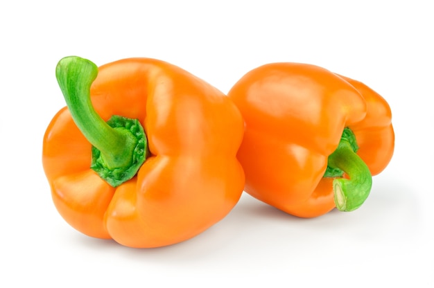 Two sweet orange pepper isolated on white surface cutout.