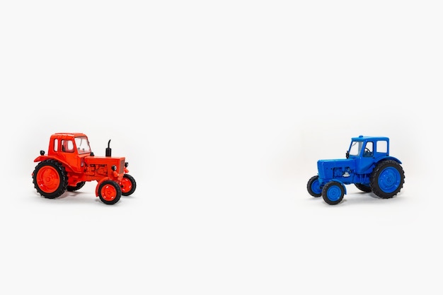 Two toy tractors realistic miniature replica on a white background