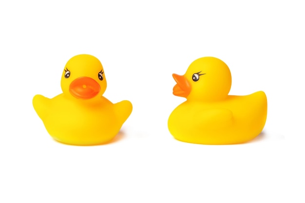 Two toy yellow rubber ducks for swimming isolated on a white background