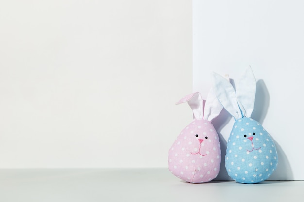 Two toys rabbits made with their own hands pink and blue