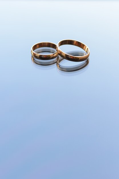 Two traditional wedding gold engagement rings lie