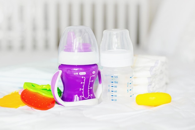 Two types of baby water bottles transparent and colored toys and diapers set of baby elements for ne