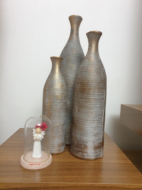 Two vases are on a table and one is labeled " the word " on the bottom. "