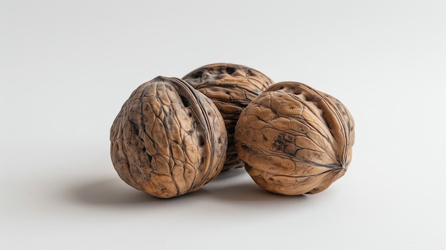 two walnuts are shown on a white background