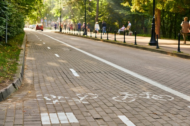 Two way cycle path and traffic car, marking bike path, white painted bicycle sign on road on street. Bike road symbol. Ride on bicycle, cycling, bicycling, wheeling and healthy lifestyle concept