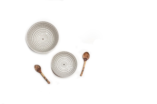 Two white and black ceramic bowls on a white background with copy space in a top view