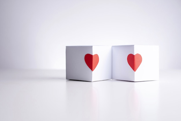 Two white boxes with red hearts ..