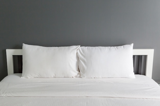 Two white pillow on bed and blanket in the bedroom