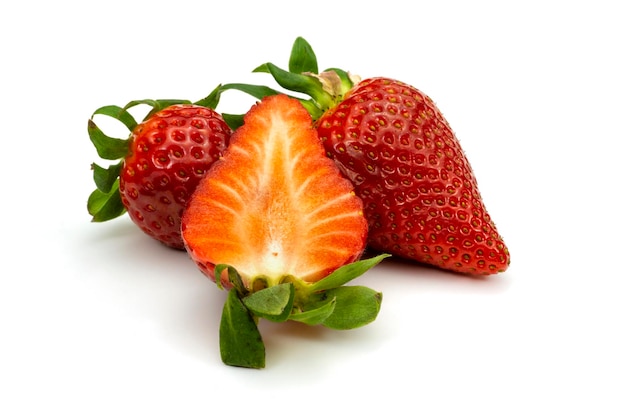 Two whole strawberry fruits and half isolated on white background