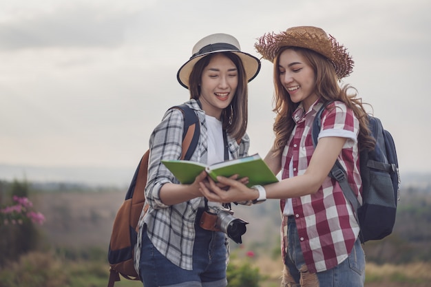 Two woman searching direction on location map while traveling 