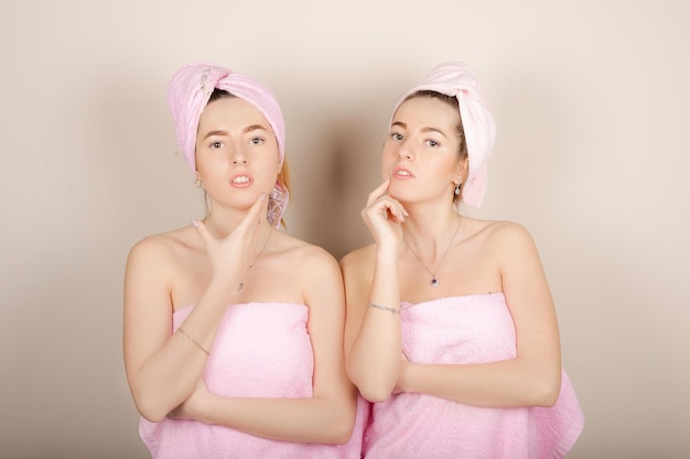 Two woman with a towel on her head