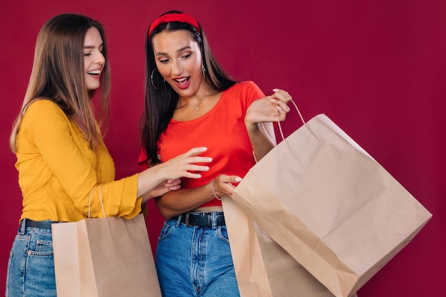 Two women are carrying shopping bags big sales and black friday